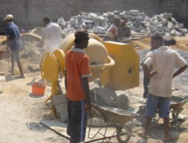 Crew mixing concrete on site